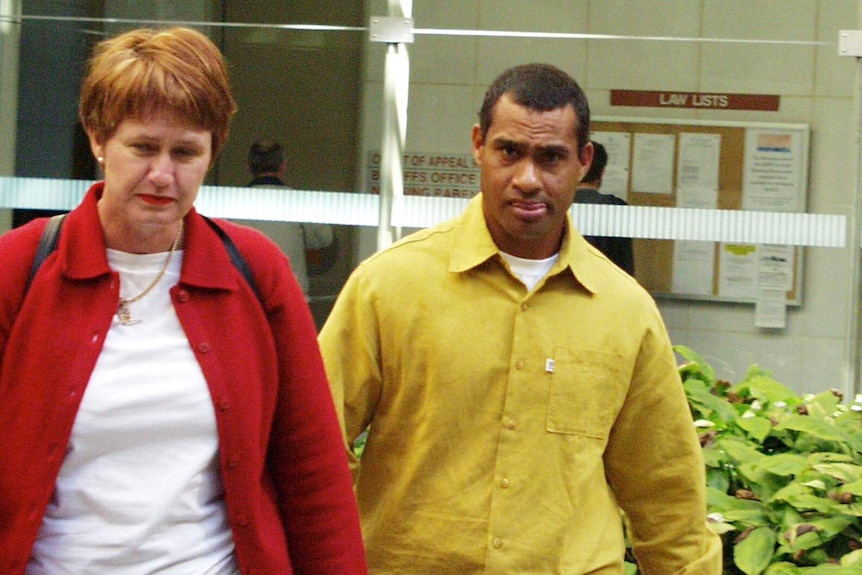 Convicted murderer Derek Bellington Sam (right) leaving Brisbane Supreme Court with his solicitor.