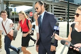 Karmichael Hunt surrounded by reporters outside Brisbane Magistrates Court