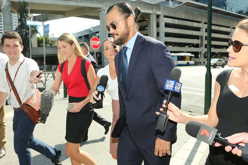 Karmichael Hunt surrounded by reporters outside Brisbane Magistrates Court