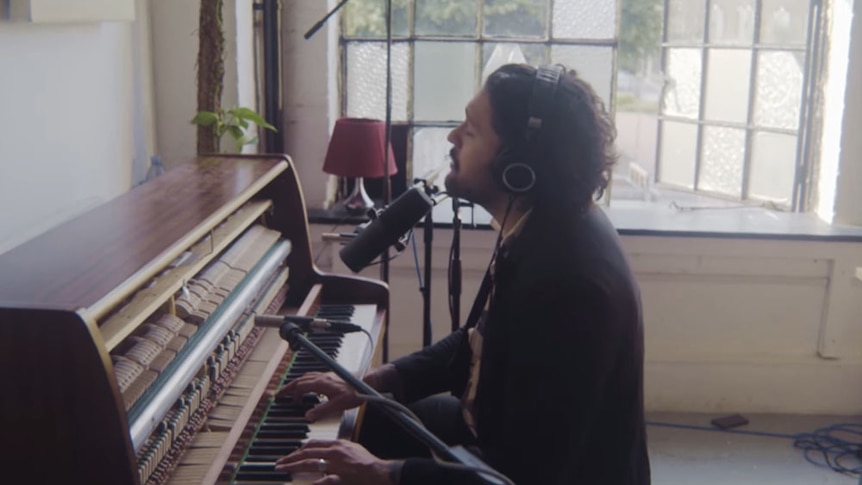 A screenshot of Gang of Youths frontman Dave Le'aupepe performing a piano version of 'the angel of 8th ave'