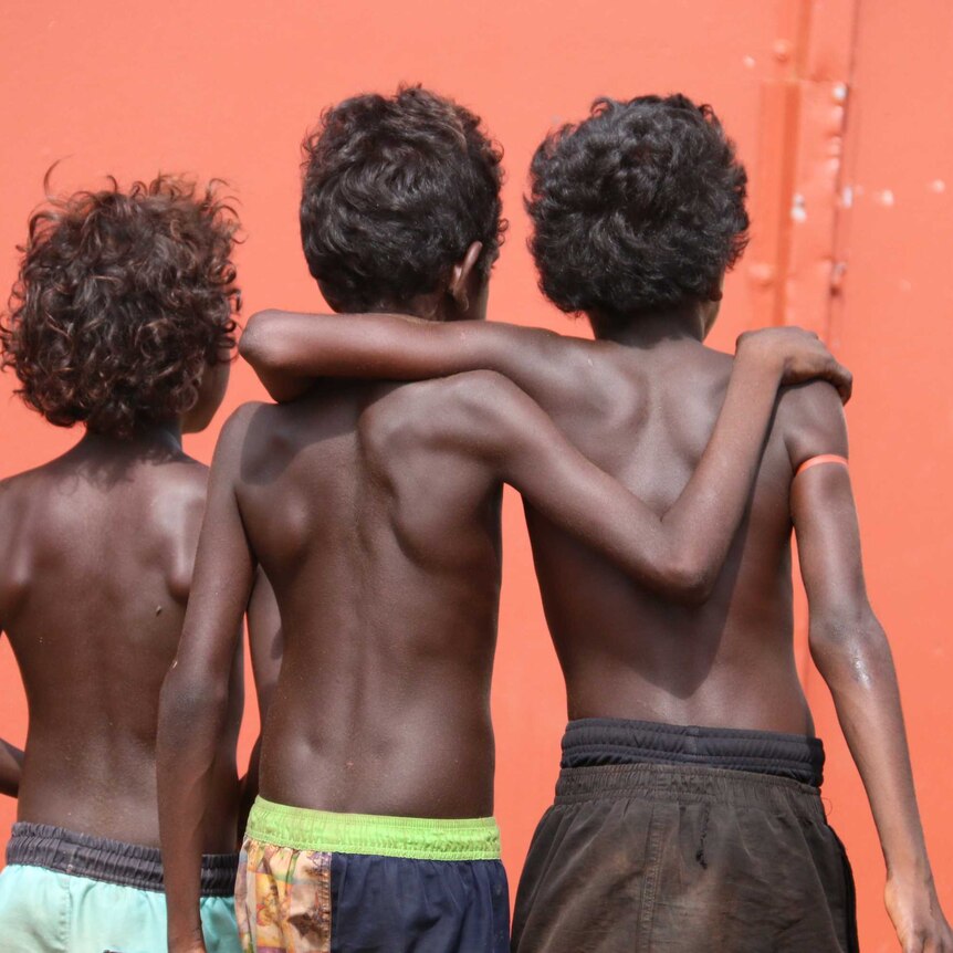 Three Aboriginal boys seen from behind.
