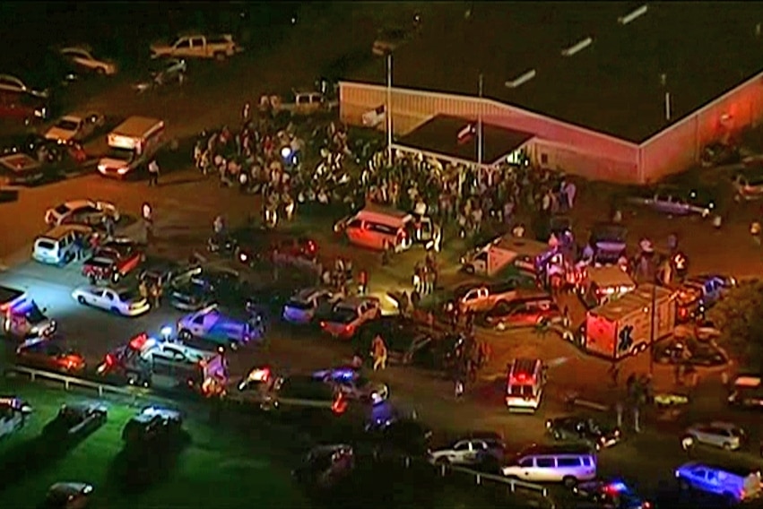 An aerial view of emergency vehicles and crowds of people in a carpark in West, Texas, after the explosion.