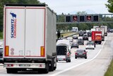 A truck and cars are stuck in a traffic jam on a German road.