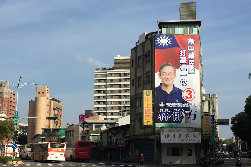 The side of a building is covered in a 'how to vote' election advertisement