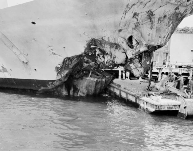 black and white image of a smashed up boat bow