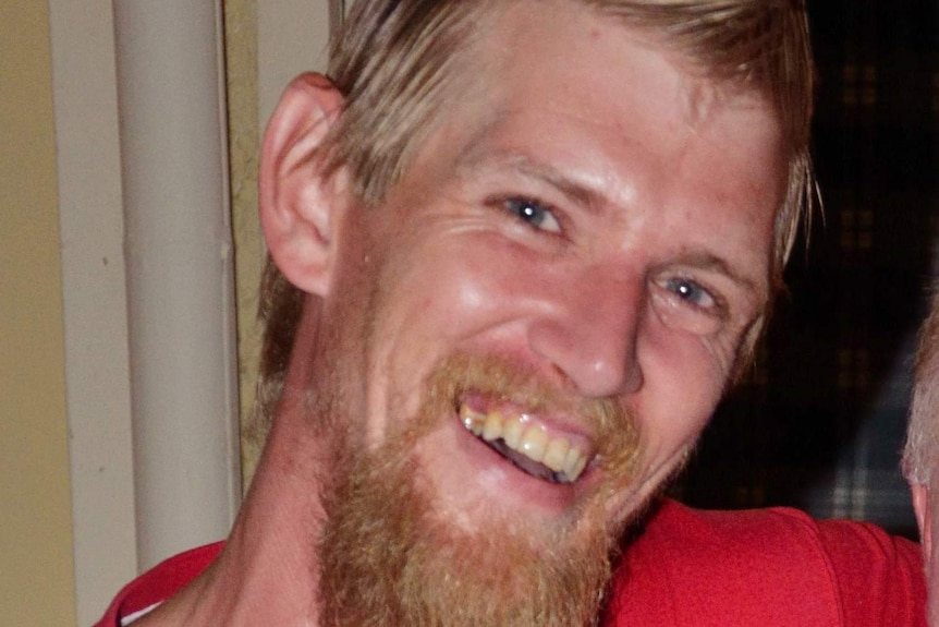 A headshot of a man with blonde-red hair and beard