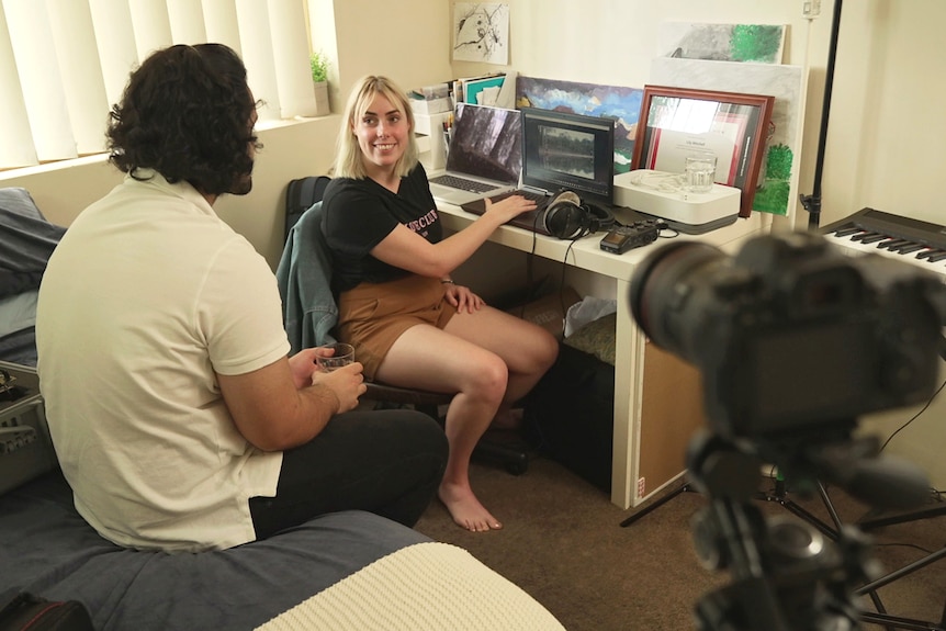 Lily Mitchell and her partner Ramin Karimi in Lily's study at home