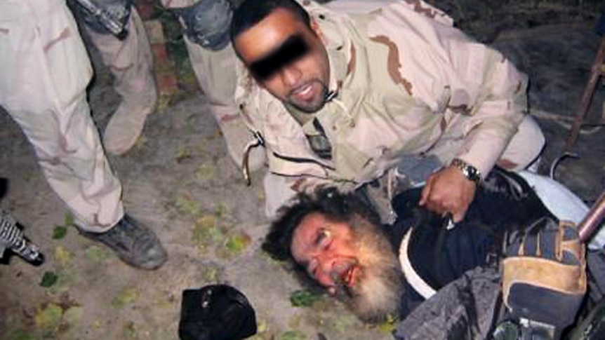 Saddam Hussein is dragged out of his hiding place by US troops