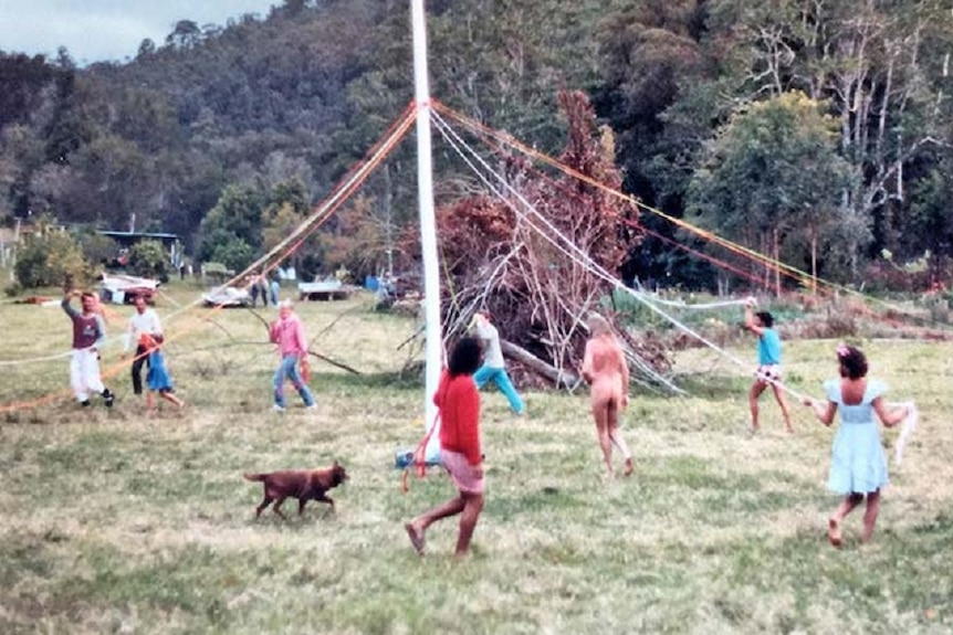 Residents of the Mandala commune in northern New South Wales dance around a maypole