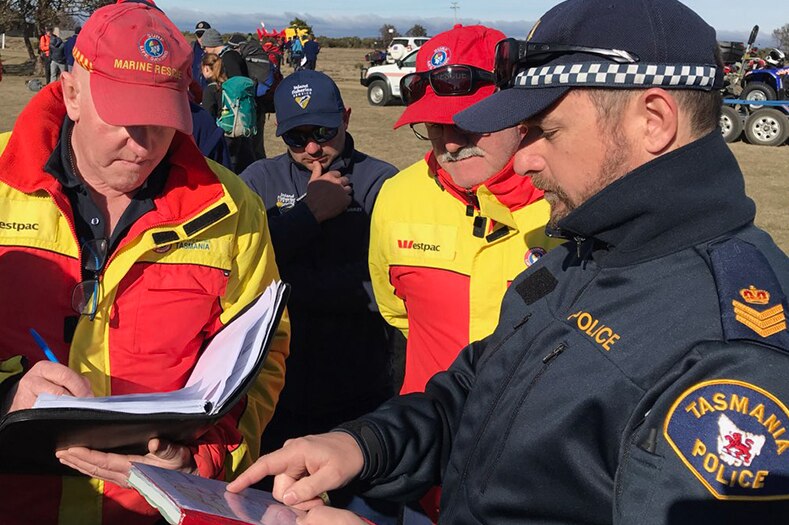 Police and surf lifesaving personnel during a briefing at the emergency exercise in Tasmanian central highlands.
