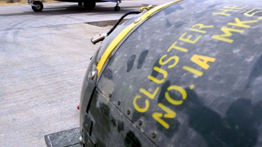 A cluster bomb sits on a bomb-trolley