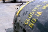 A cluster bomb sits on a bomb-trolley