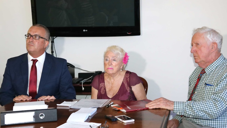 Lawyer John Hammond sits with clients Marye Louise Daniels and Ron McLean