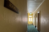 The hallway of the castle hotel, including a door and an exit sign