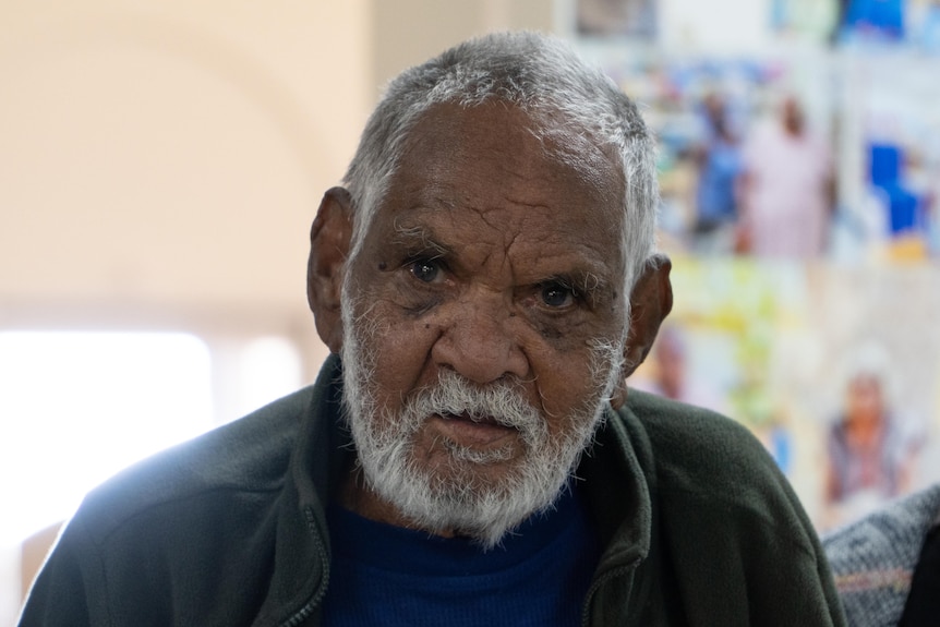 An older Indigenous man with short, white hair and a neat white beard.