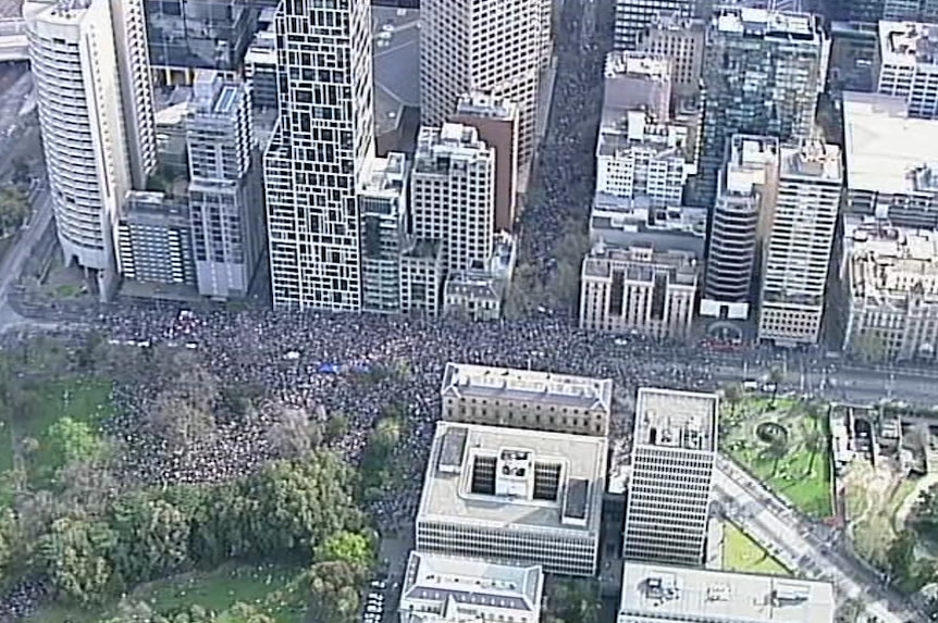 An aerial view of a protest in Melbourne shows tens and tens of thousands of people walking through the streets.