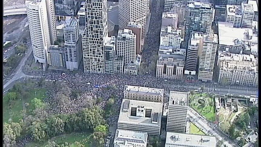 An aerial view of a protest in Melbourne shows tens and tens of thousands of people walking through the streets.