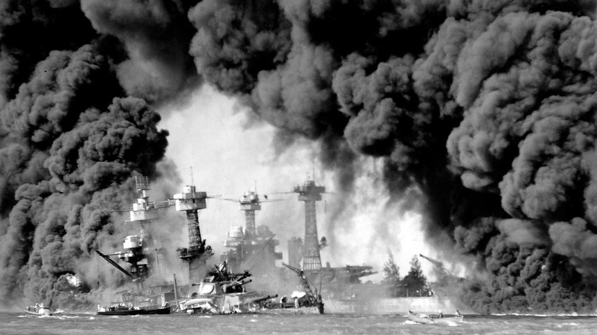 Smoke billows from several of the ships that were bombed at Pearl Harbour.
