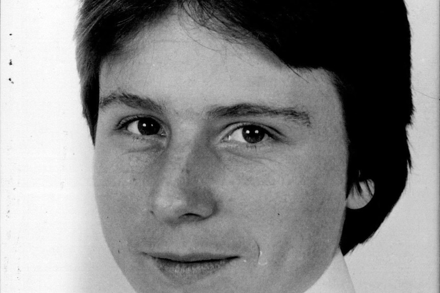 A black and white photograph of a 1980s teenager in work attire