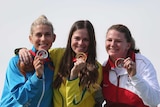Laetisha Scanlan on the podium with her trap-shooting gold medal