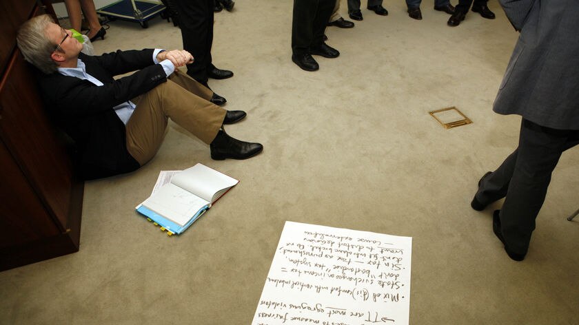 Prime Minister Kevin Rudd sits on the floor during 2020 summit discussions