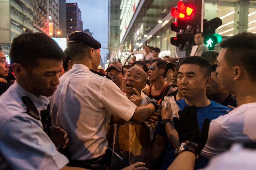 A man threatens pro-democracy protestors in Hong Kong