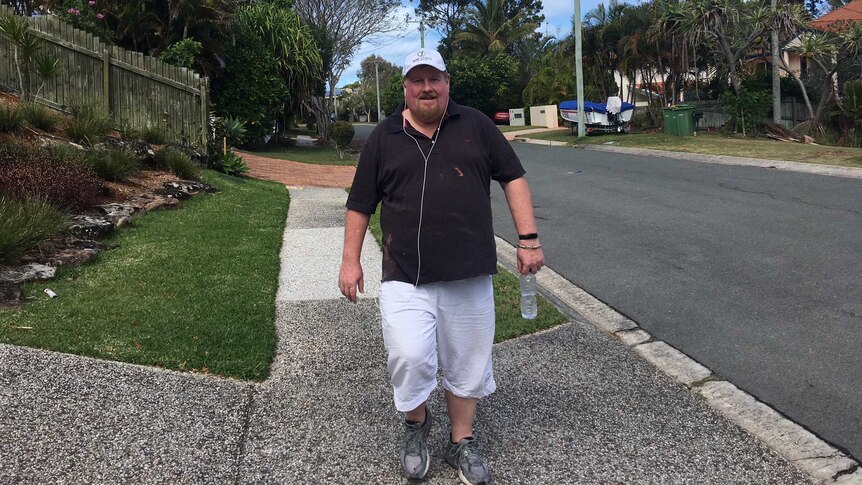 Gary Fitzgerald walking down a suburban street as part of his exercise routine.