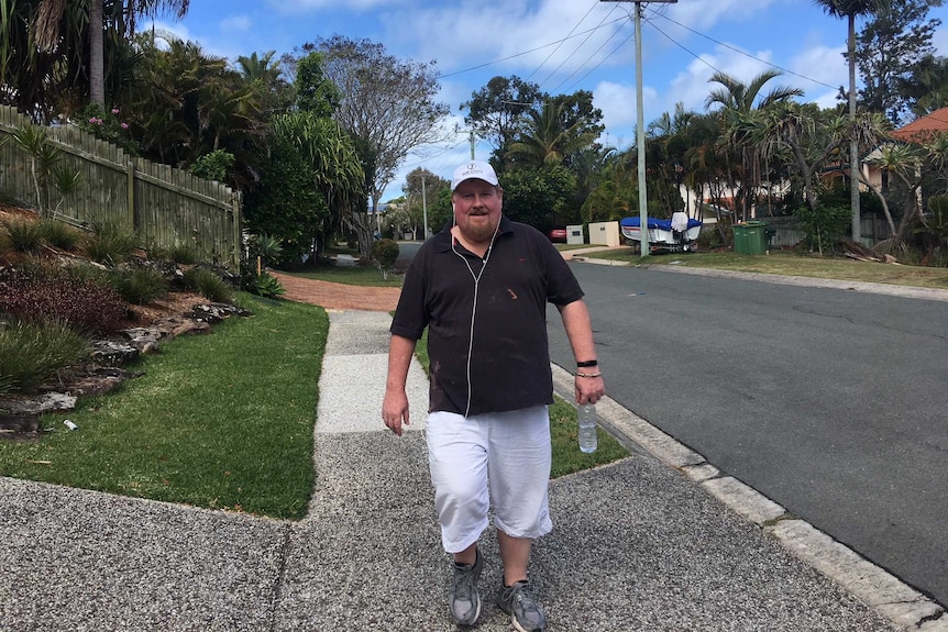 Gary Fitzgerald walking down a suburban street as part of his exercise routine.