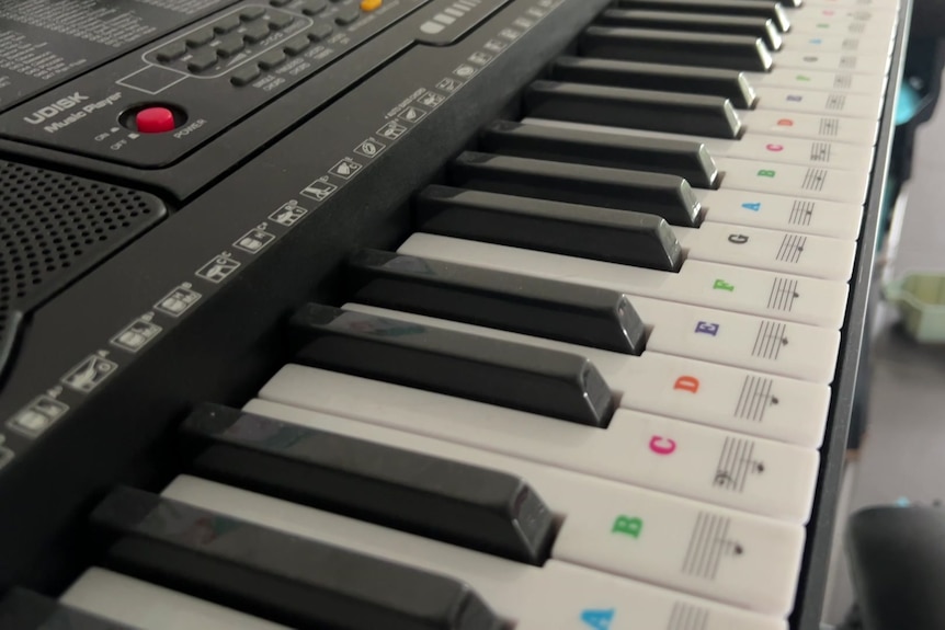 A keyboard with stickers to assist with learning the instrument.