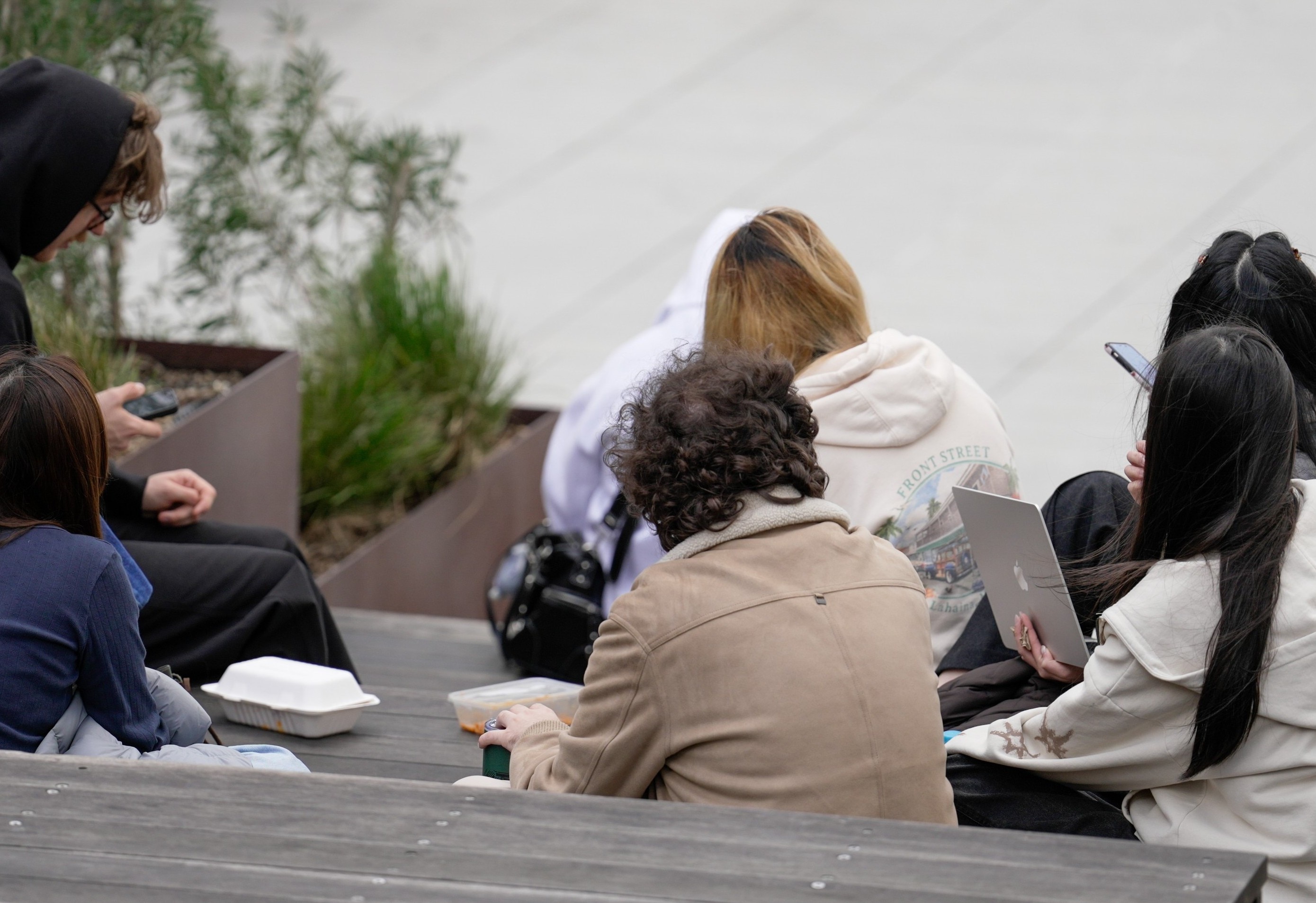 A group of unidentified students sitting in a university campus