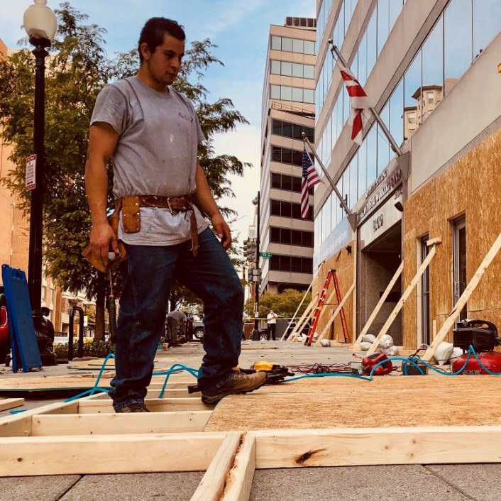 A construction worker looks at wooden boards on a street in Washington DC