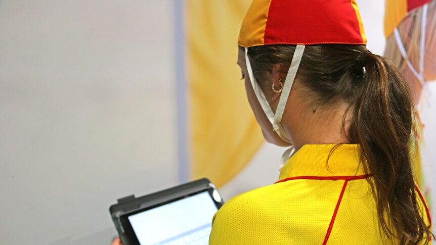 A surf life saver uses new tablet technology