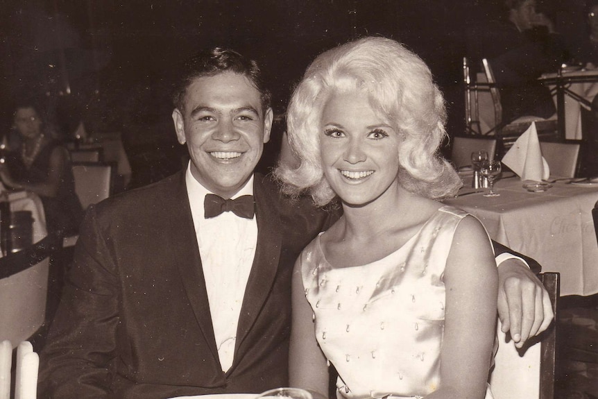 A young Ricky May in a bowtie sits next to Colleen.