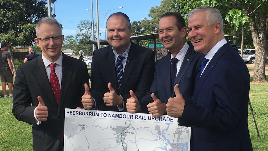 Paul Fletcher, Ted O'Brien, Andrew Wallace and Michael McCormack give thumbs up above a rail line map