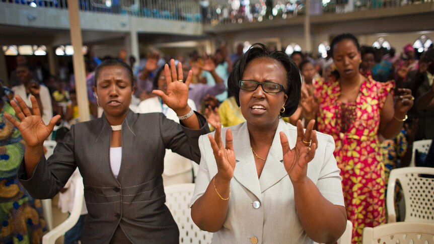 Rwandans sing and pray at the Evangelical Restoration Church