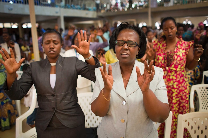 Rwandans sing and pray at the Evangelical Restoration Church