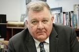 Close up of Craig Kelly in office