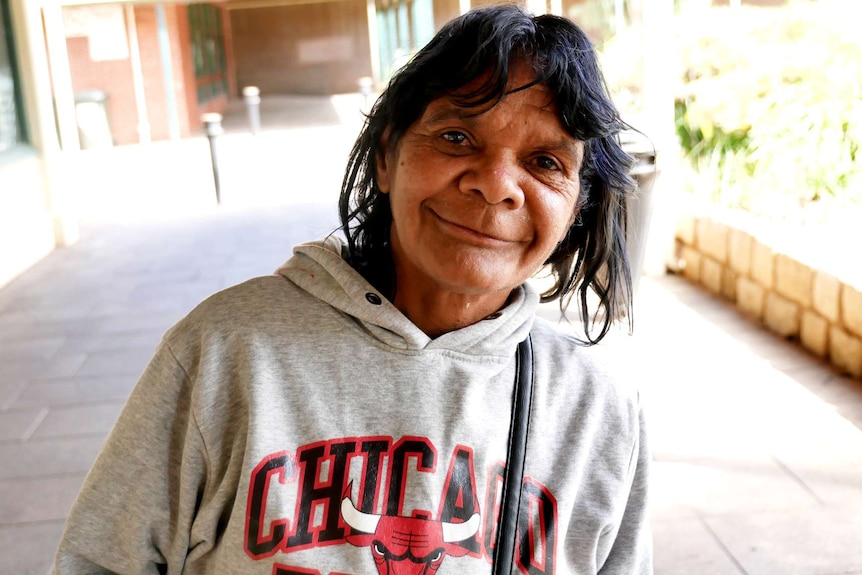 A woman wearing a Chicago Bulls jumper smiling at the camera.