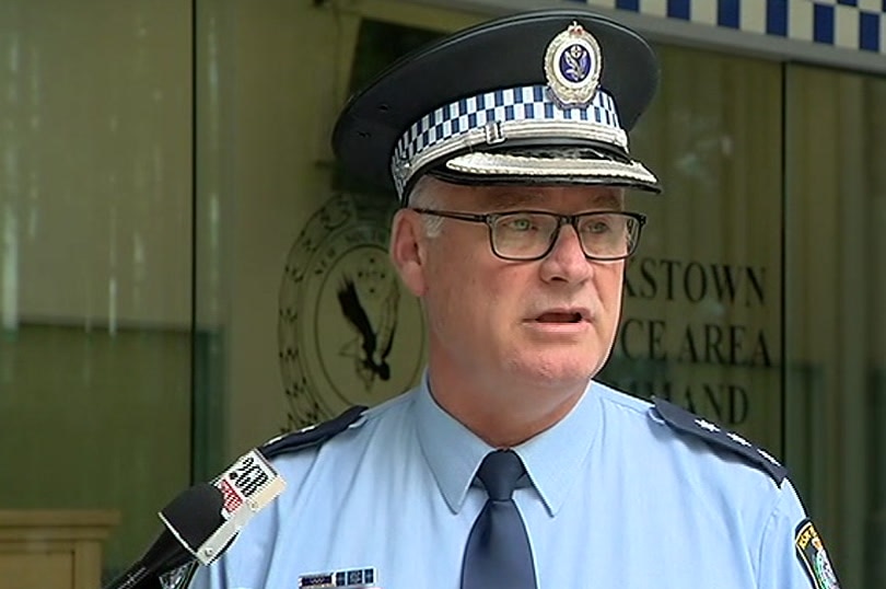 police officer addressing the media outside police station