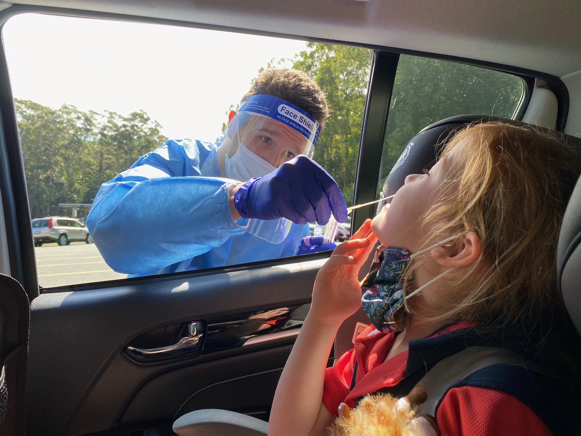 A young girl is tested for COVID-19