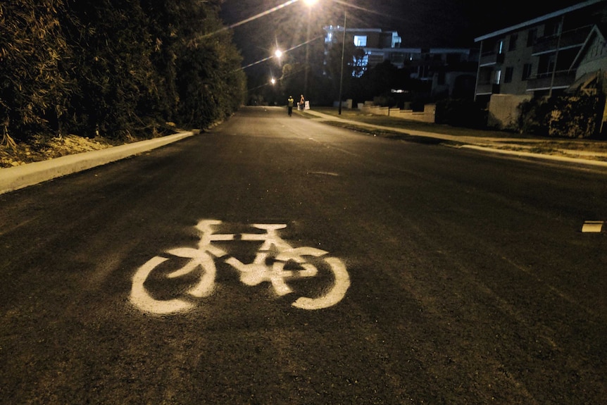 A white bike priority marking spray painted on Rutland Avenue in Victoria Park in Perth.