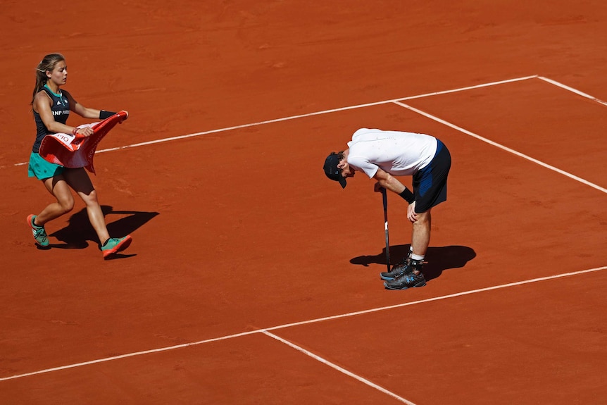 Britain's Andy Murray leans on his racquet against Switzerland's Stan Wawrinka at the French Open.