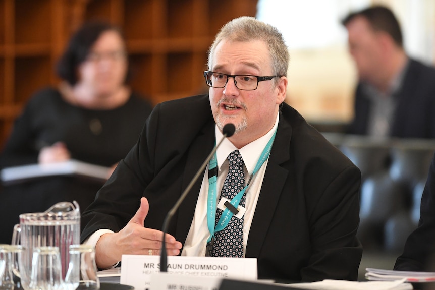 Queensland Health's Shaun Drummond is seen during questioning in an Estimates Hearing at Parliament House in 2018