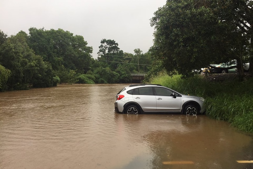 A car alone in a flooded carpark on the Sunshine Coast