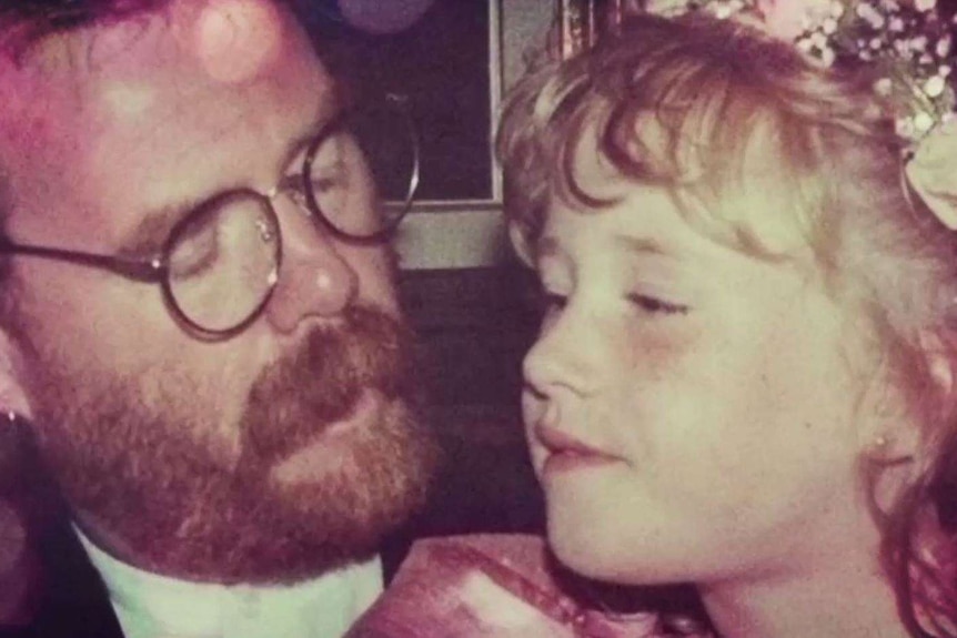 A photograph of a man with glasses with his daughter