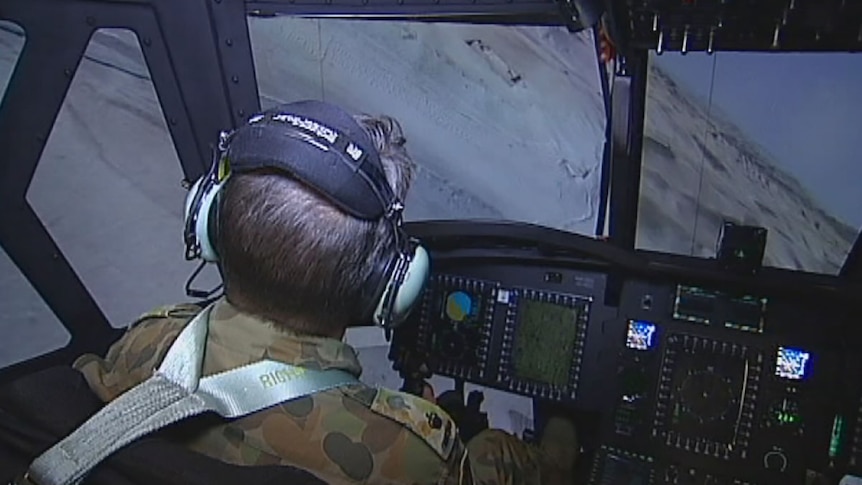 Senior flying instructor David Poole at the controls of a Chinook simulator.