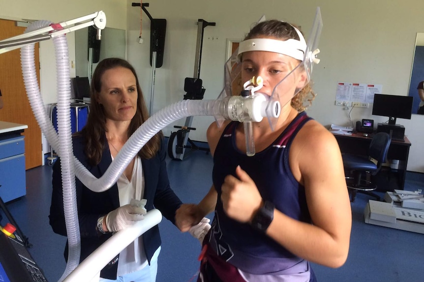 Clare Minahan monitors Rosie Malone who is hooked up with a breathing apparatus, running on a treadmill