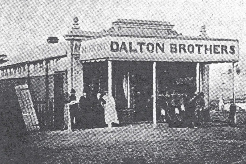 Black and white grainy photograph of an 1800s store with the words Dalton Brothers on the front