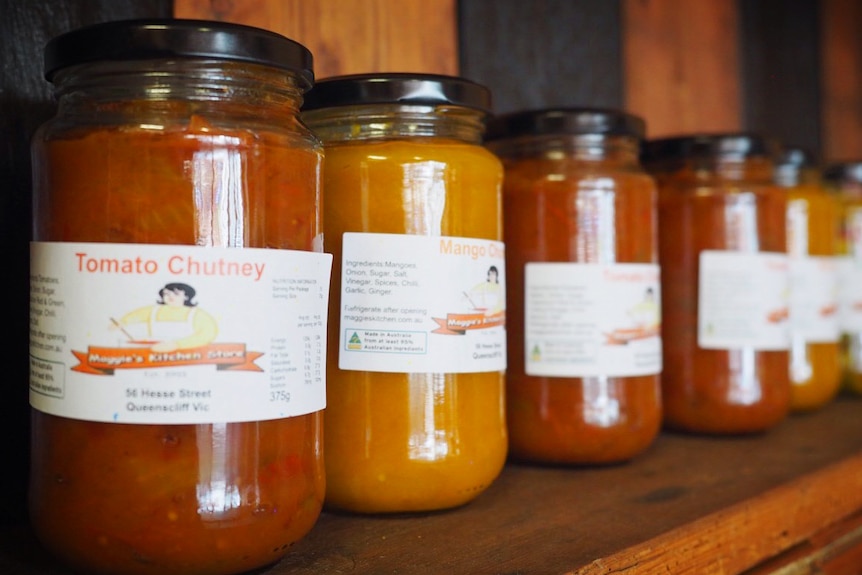 Jars of relish sit on a shelf