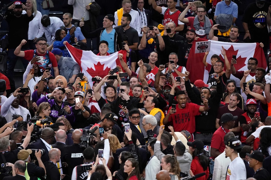 Fans and Toronto Raptors players celebrate